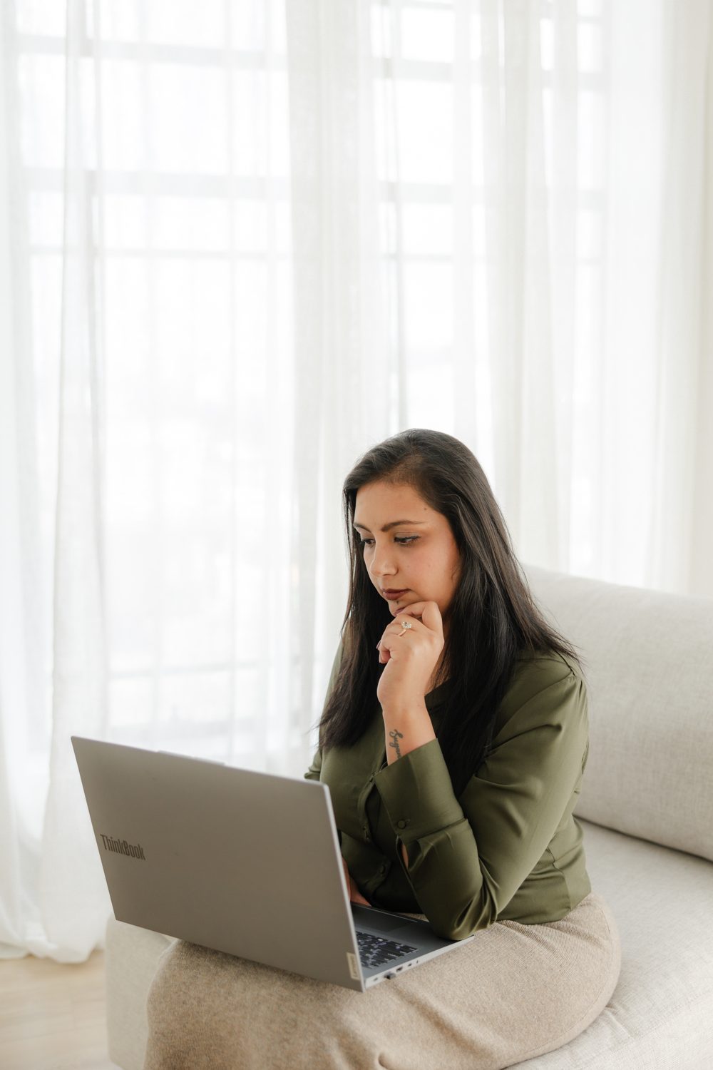 Sugandha Arora reviewing a client's cover on her laptop